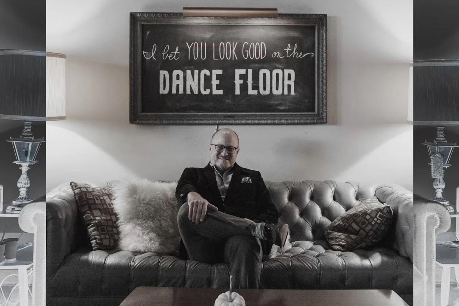 Karl on the chesterfield under I Bet You Look Good On The Dance Floor sign
