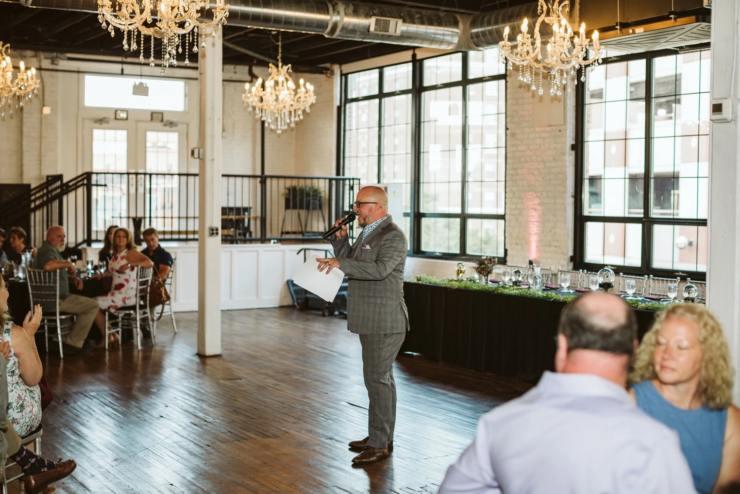 Karl MC toast under chandeliers at Warehouse 109